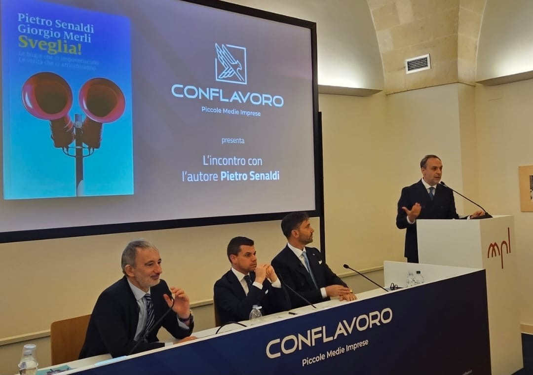 La presentazione del libro Sveglia! a Matera, con i relatori al tavolo e il logo Conflavoro sullo schermo.